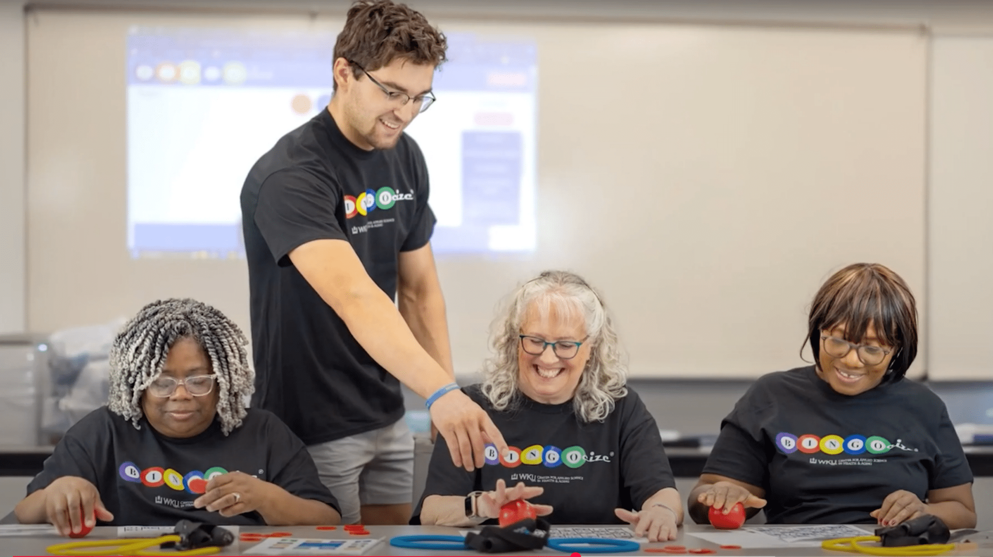 Man and three women playing Bingocize game